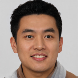 Joyful asian young-adult male with short  black hair and brown eyes