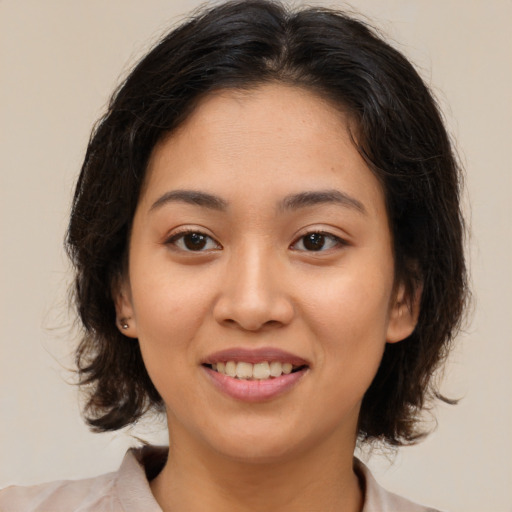 Joyful white young-adult female with medium  brown hair and brown eyes