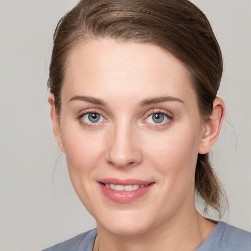 Joyful white young-adult female with medium  brown hair and blue eyes