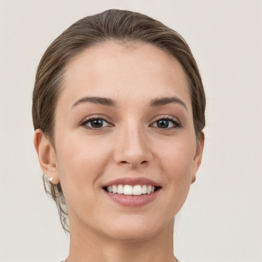 Joyful white young-adult female with short  brown hair and grey eyes