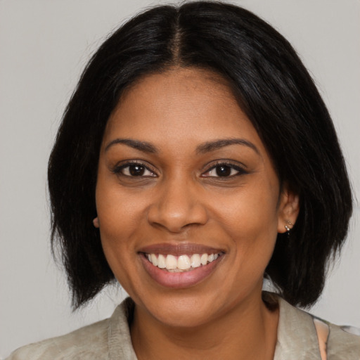 Joyful black young-adult female with medium  brown hair and brown eyes