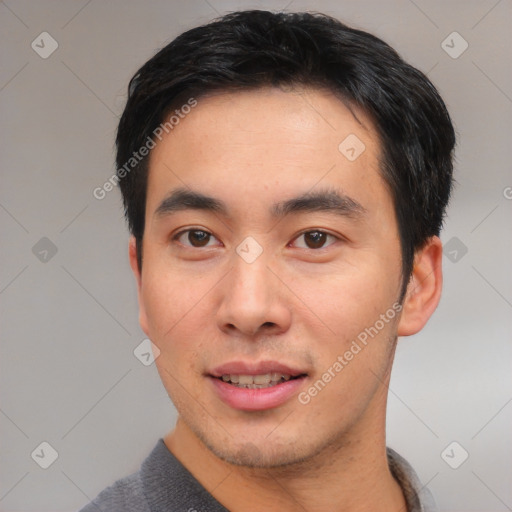 Joyful asian young-adult male with short  black hair and brown eyes