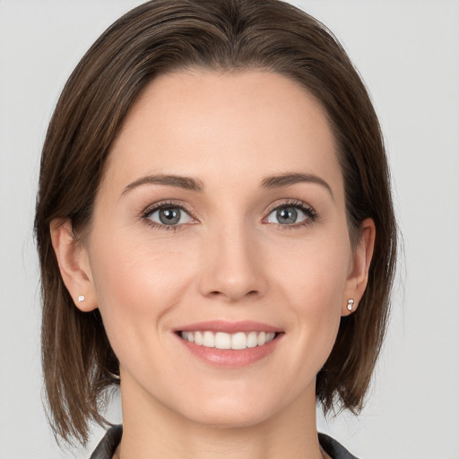 Joyful white young-adult female with medium  brown hair and grey eyes