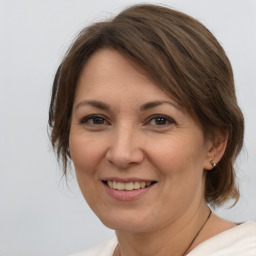 Joyful white adult female with medium  brown hair and brown eyes