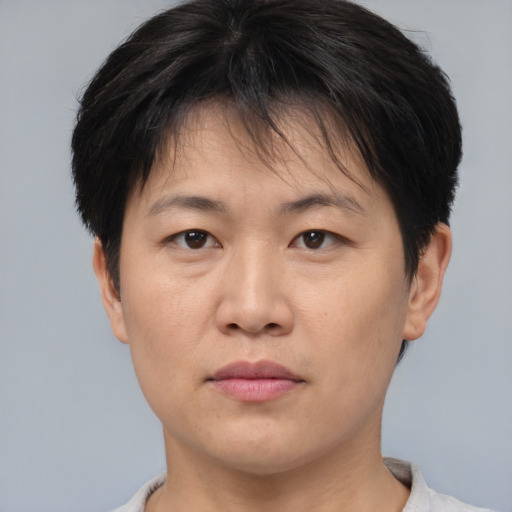 Joyful asian young-adult female with short  brown hair and brown eyes