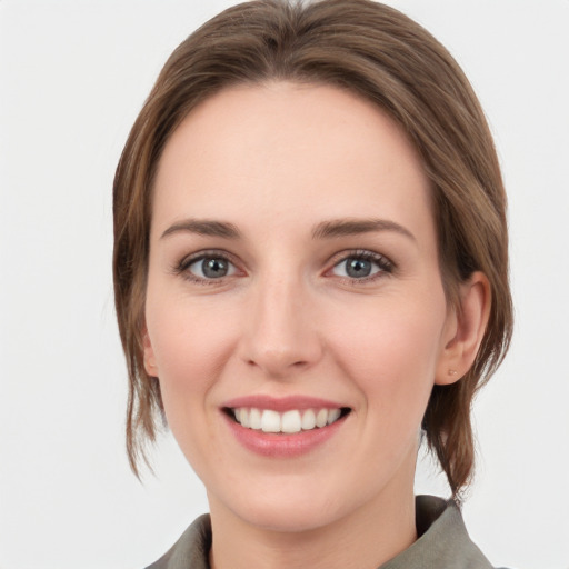 Joyful white young-adult female with medium  brown hair and grey eyes