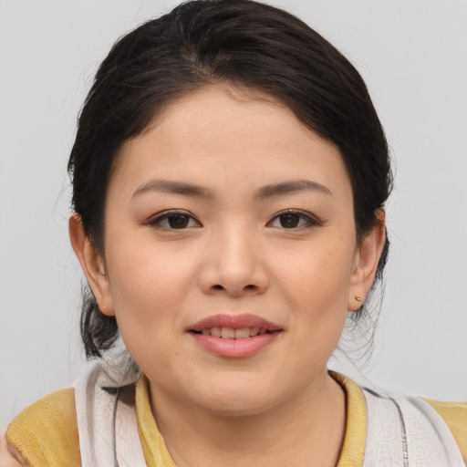 Joyful asian young-adult female with medium  brown hair and brown eyes