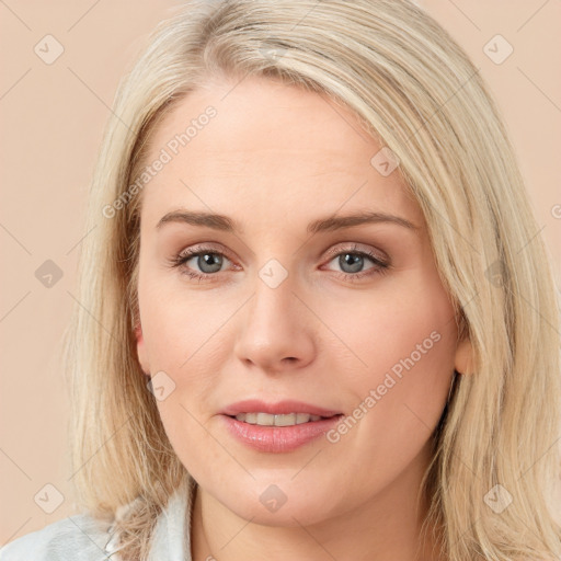 Joyful white young-adult female with long  brown hair and blue eyes