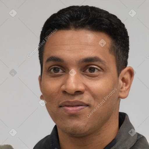 Joyful black young-adult male with short  black hair and brown eyes