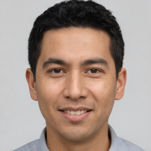 Joyful white young-adult male with short  black hair and brown eyes