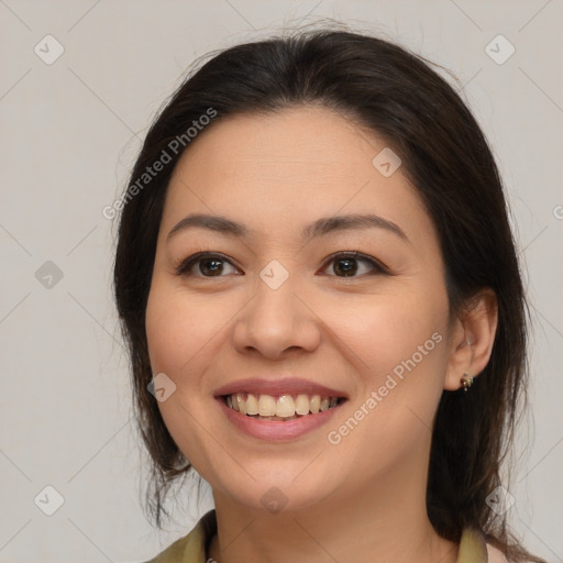 Joyful latino young-adult female with medium  brown hair and brown eyes