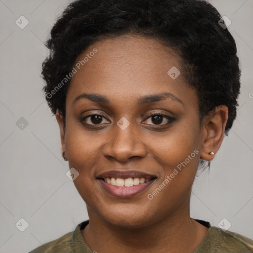 Joyful black young-adult female with short  black hair and brown eyes