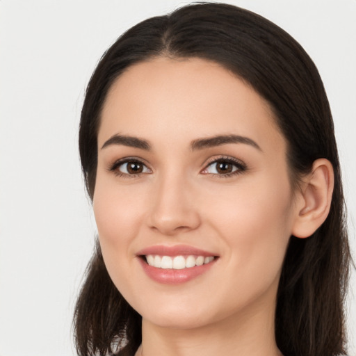 Joyful white young-adult female with long  brown hair and brown eyes