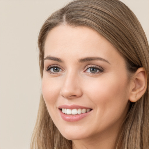 Joyful white young-adult female with long  brown hair and grey eyes