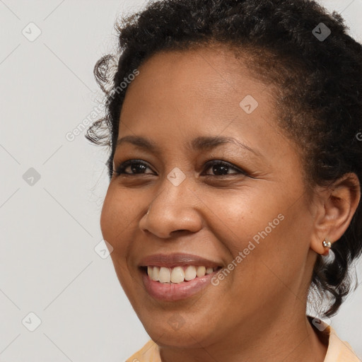 Joyful black young-adult female with short  brown hair and brown eyes