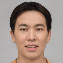 Joyful asian young-adult male with short  brown hair and brown eyes