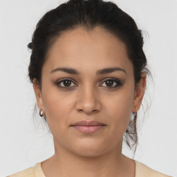 Joyful latino young-adult female with medium  brown hair and brown eyes