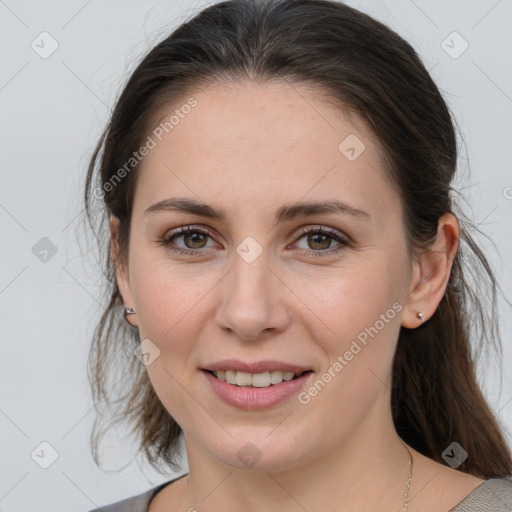 Joyful white young-adult female with medium  brown hair and grey eyes