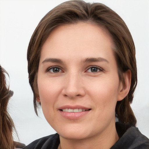 Joyful white young-adult female with medium  brown hair and brown eyes