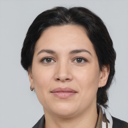 Joyful white adult female with medium  black hair and brown eyes