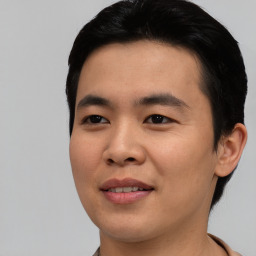 Joyful asian young-adult male with short  black hair and brown eyes