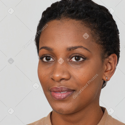 Joyful black young-adult female with short  black hair and brown eyes