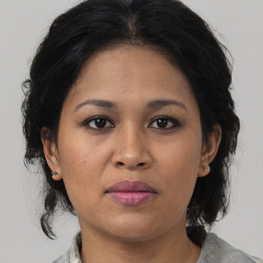 Neutral latino adult female with medium  brown hair and brown eyes
