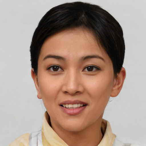 Joyful asian young-adult female with short  brown hair and brown eyes