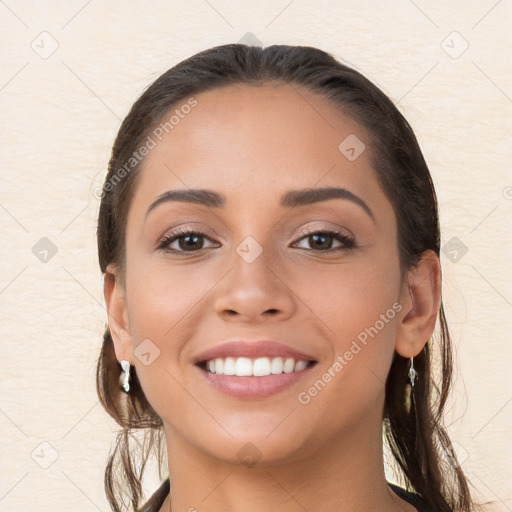 Joyful white young-adult female with long  brown hair and brown eyes