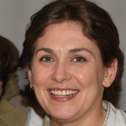 Joyful white adult female with medium  brown hair and brown eyes