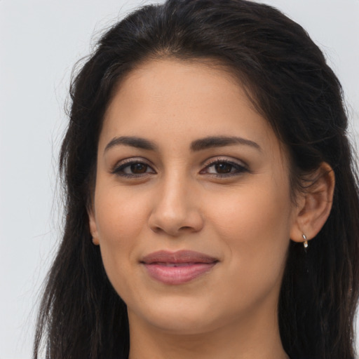 Joyful latino young-adult female with long  brown hair and brown eyes