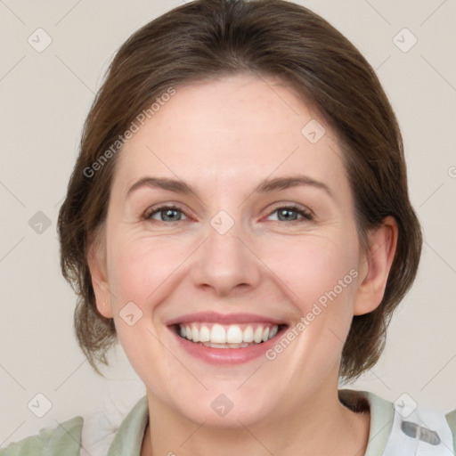 Joyful white adult female with medium  brown hair and grey eyes