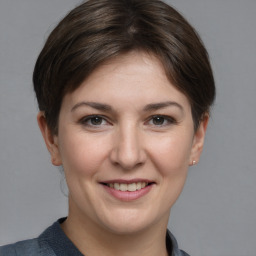 Joyful white young-adult female with medium  brown hair and grey eyes