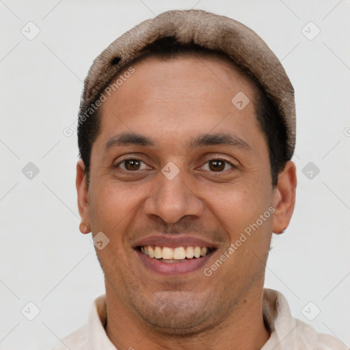 Joyful latino young-adult male with short  brown hair and brown eyes