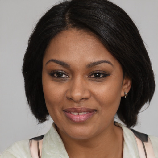 Joyful black young-adult female with medium  brown hair and brown eyes