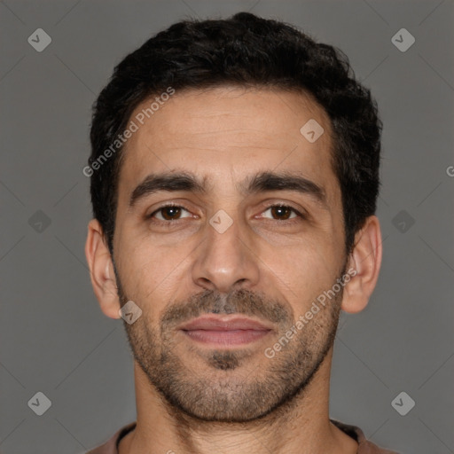 Joyful white young-adult male with short  black hair and brown eyes