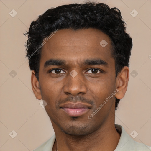 Joyful black young-adult male with short  black hair and brown eyes