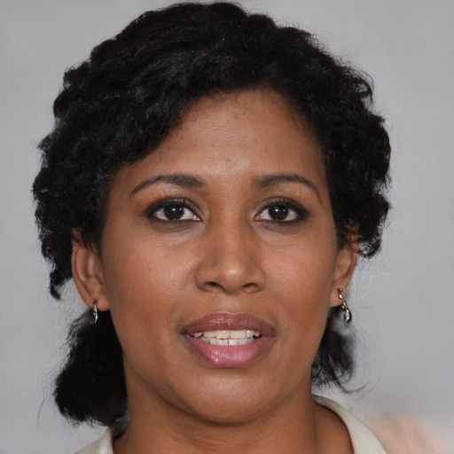 Joyful black young-adult female with short  brown hair and brown eyes
