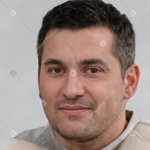 Joyful white adult male with short  black hair and brown eyes