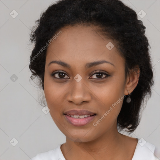 Joyful black young-adult female with long  black hair and brown eyes