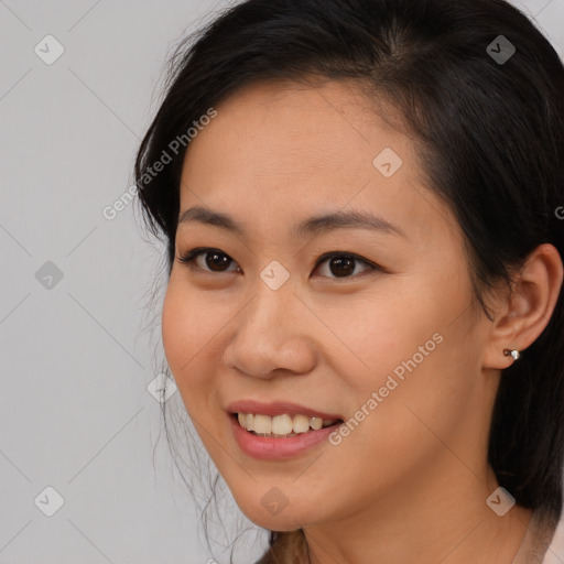 Joyful asian young-adult female with medium  brown hair and brown eyes