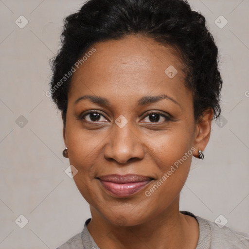 Joyful black adult female with short  black hair and brown eyes