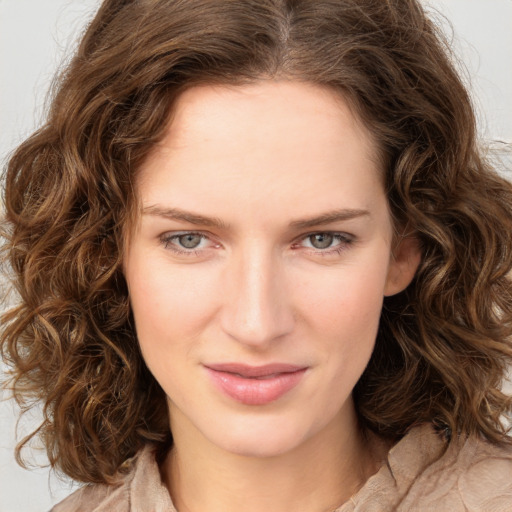 Joyful white young-adult female with medium  brown hair and green eyes