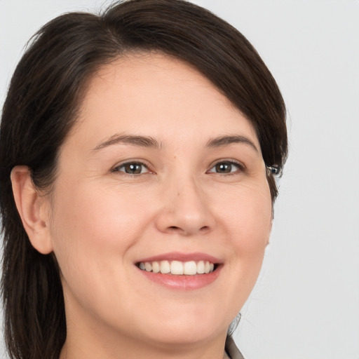 Joyful white young-adult female with medium  brown hair and brown eyes