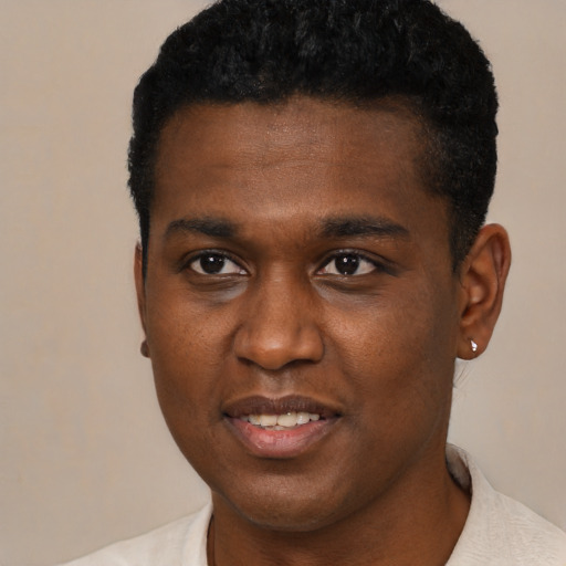Joyful black young-adult male with short  black hair and brown eyes