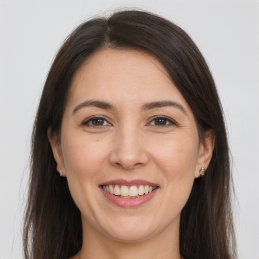 Joyful white young-adult female with long  brown hair and brown eyes