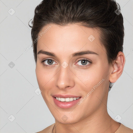 Joyful white young-adult female with short  brown hair and brown eyes