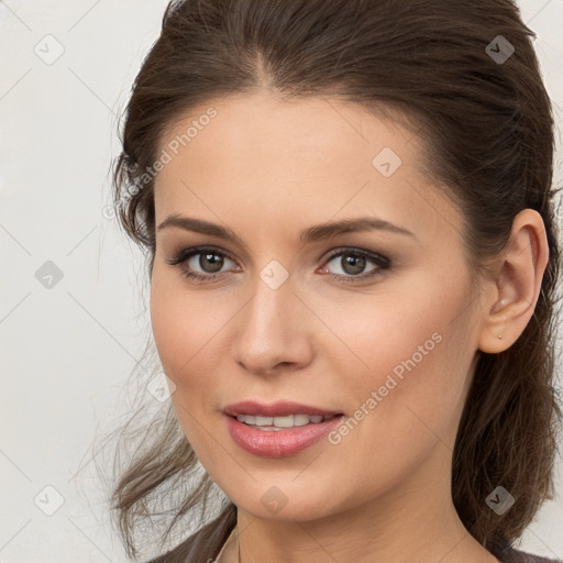 Joyful white young-adult female with long  brown hair and brown eyes