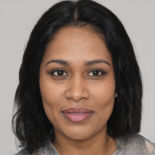 Joyful black adult female with medium  brown hair and brown eyes