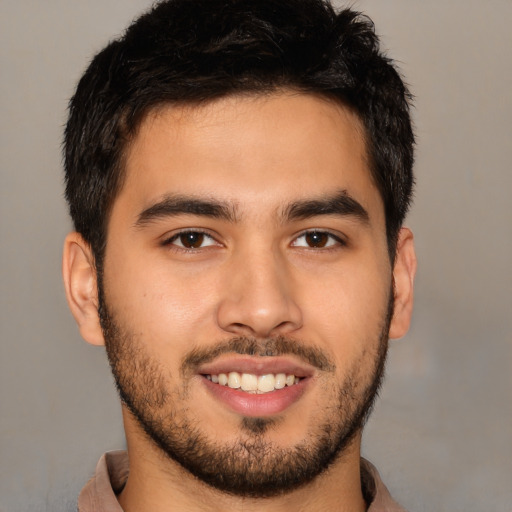 Joyful asian young-adult male with short  brown hair and brown eyes